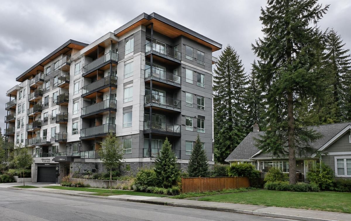 A mid-rise condominium building among trees
