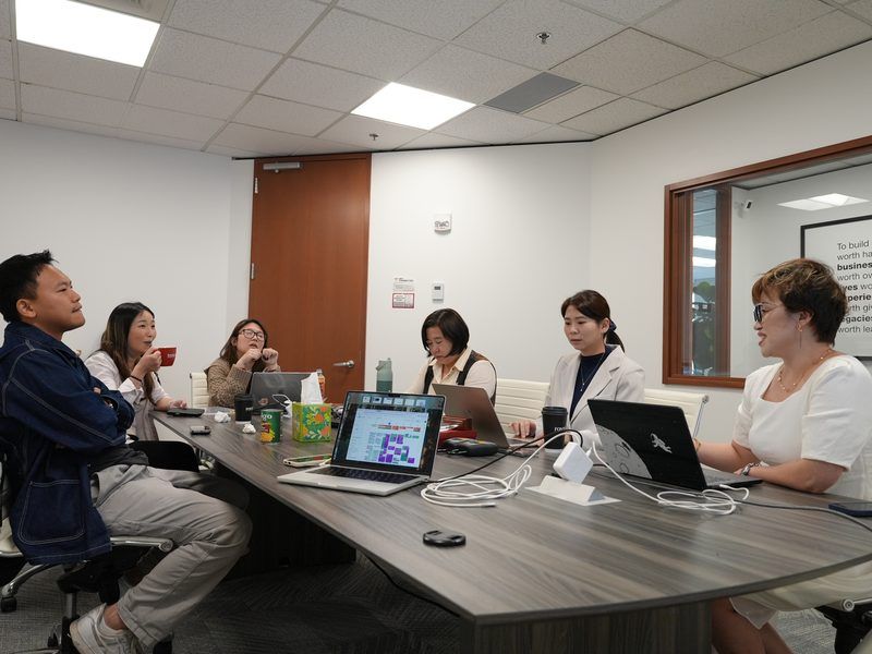 Weekly strategy meeting at the Maggie Sun Real Estate office in Bellevue